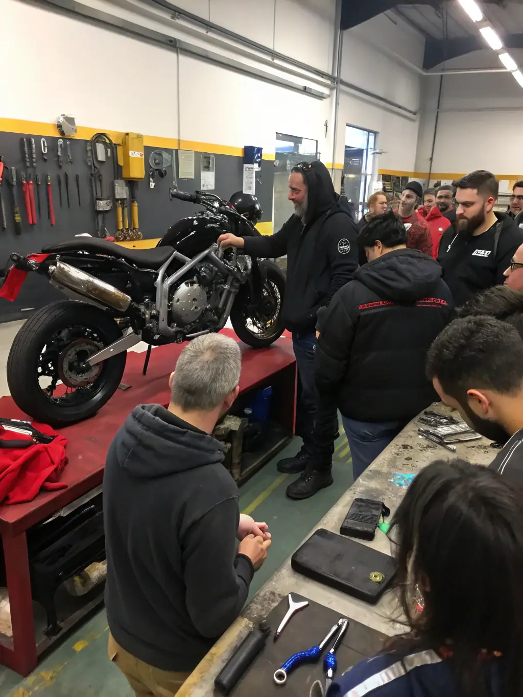 Participants gather for a workshop on motorcycle maintenance and repair, part of MOTO VERTE EVOLUTION's skill development initiatives.